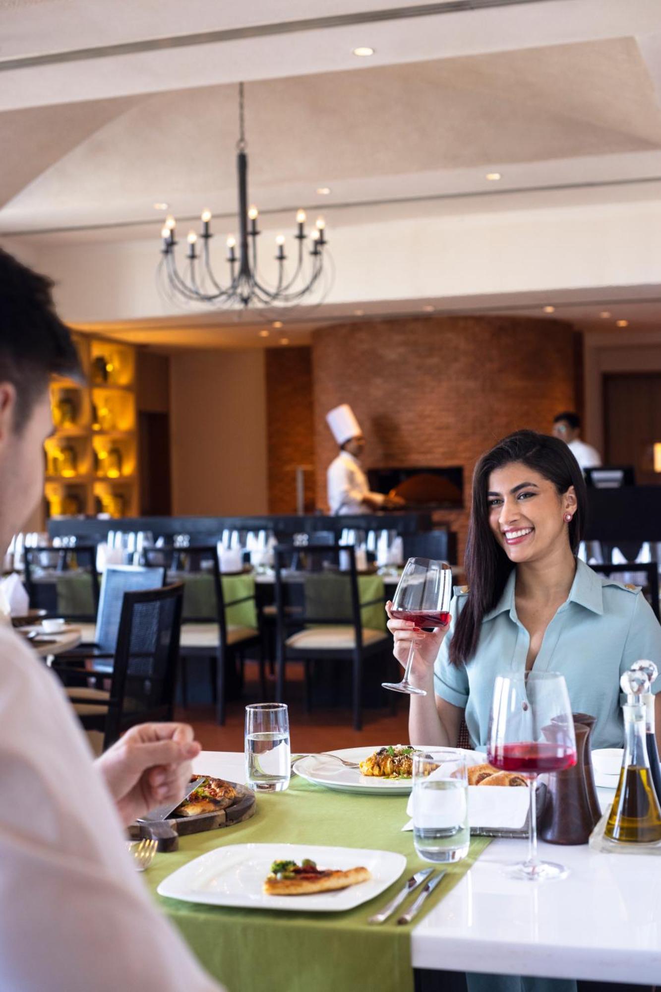 Hotel Trident Hajdarabad Zewnętrze zdjęcie A woman drinking wine